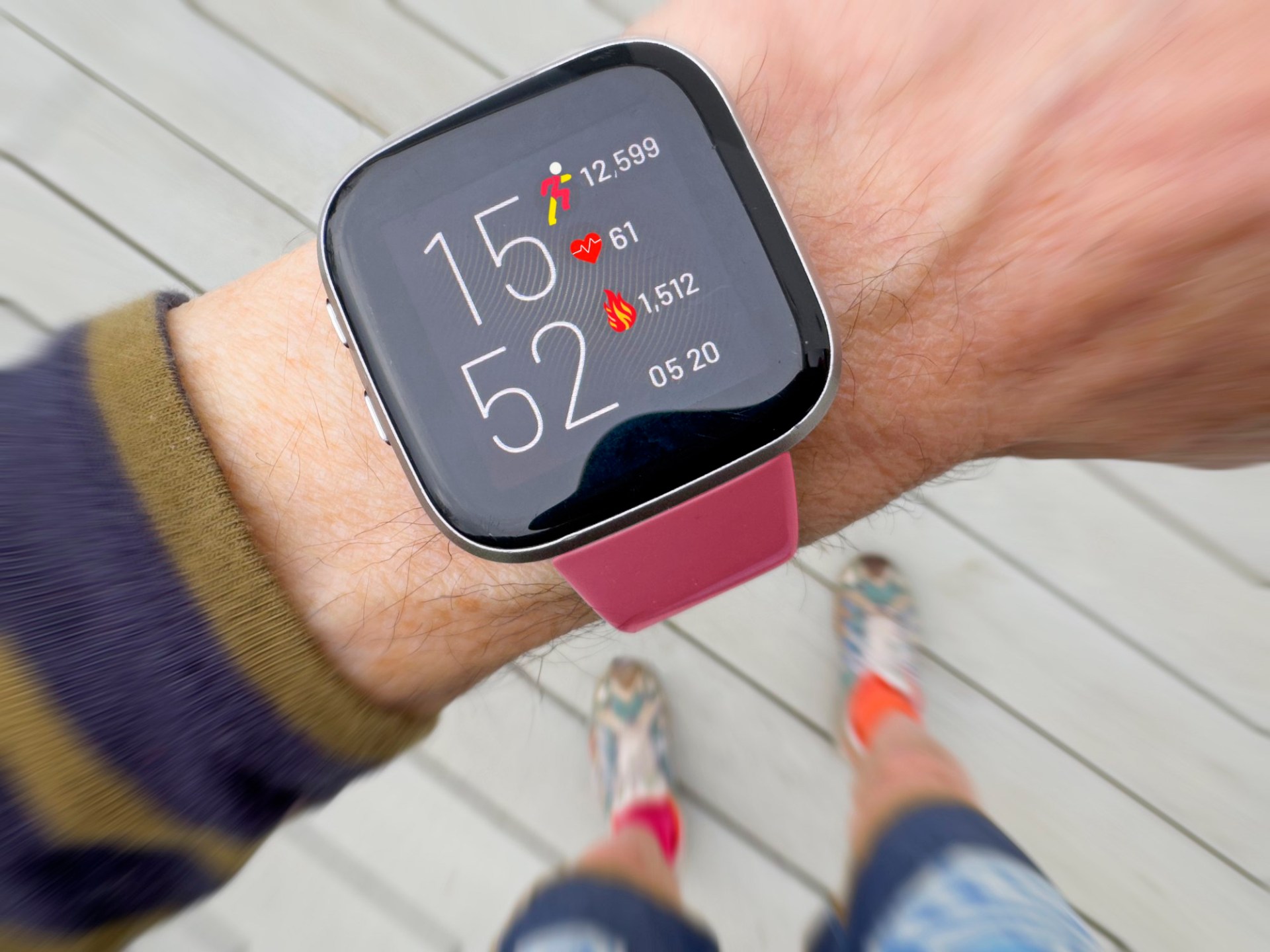 Fitness watch showing calories and step count.