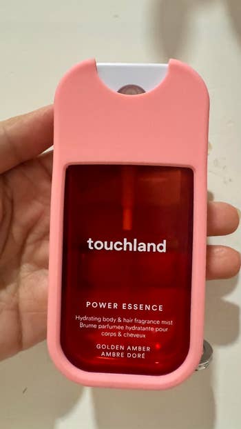 hand holding touchland hand sanitizer with case