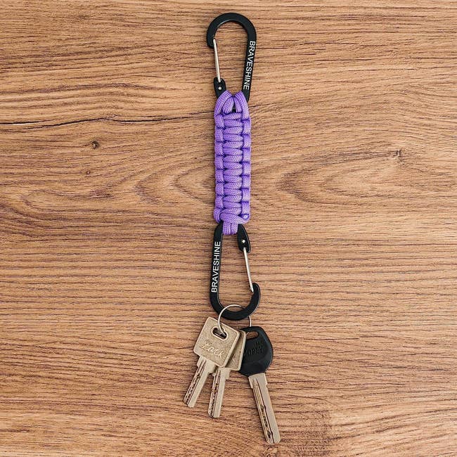 Keychain with a purple braided loop, metal carabiner clips, and keys connected