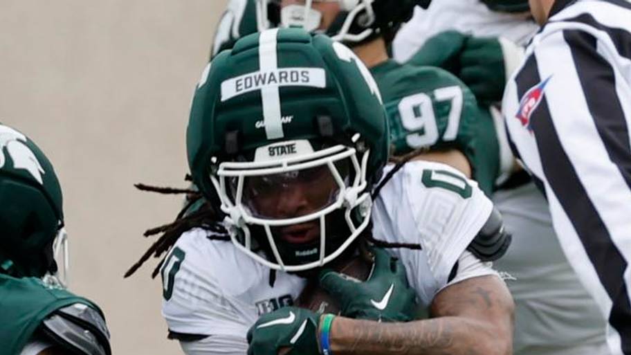 Michigan State running back Cam Edwards (0) tries to avoid defensive back Michael Richard (7)