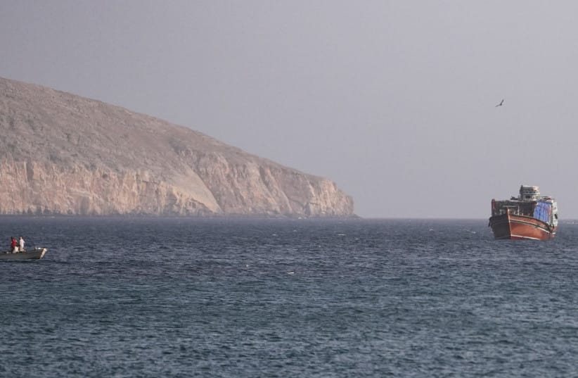 A vessel in the Strait of Hormuz, as seen from Musandam, Oman, July 16, 2026 (credit: REUTERS/STRINGER)