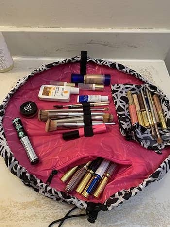 Makeup products organized on an open flat pouch