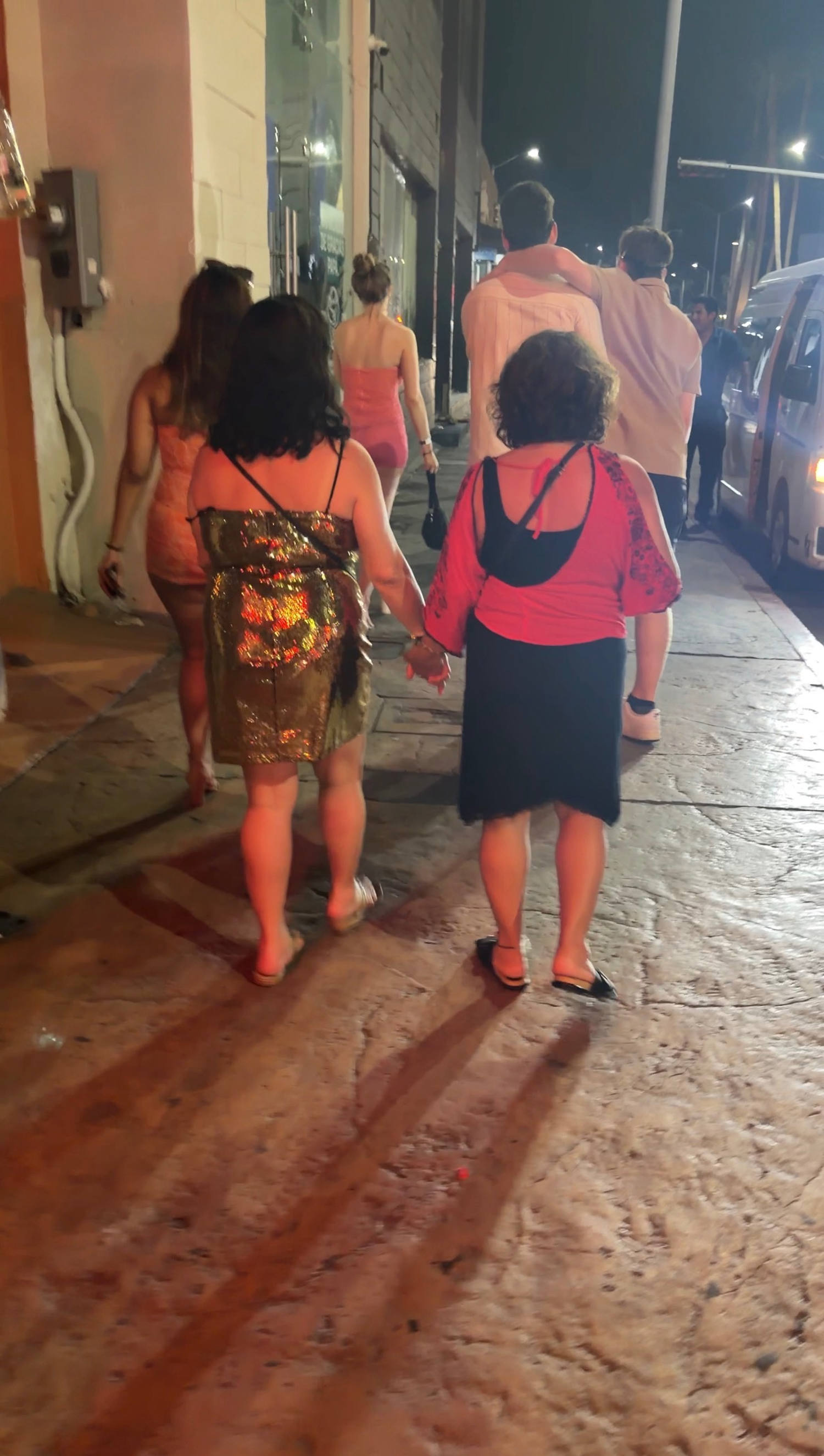Mariam and Marisu walking hand-in-hand on the way back from a club in Cabo. (Courtesy Alexandra Bushman)