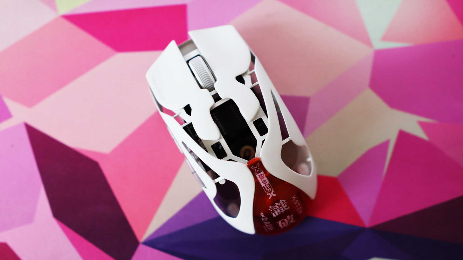 AngryMiao AM Infinity.97 gaming mouse on a colorful desk
