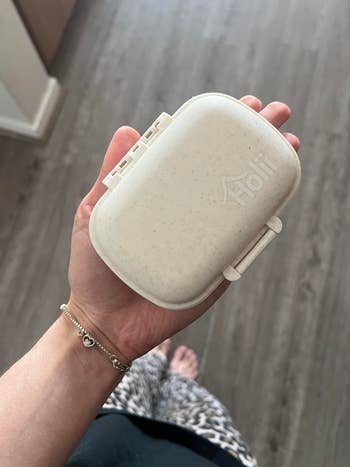 person holding pill organizer
