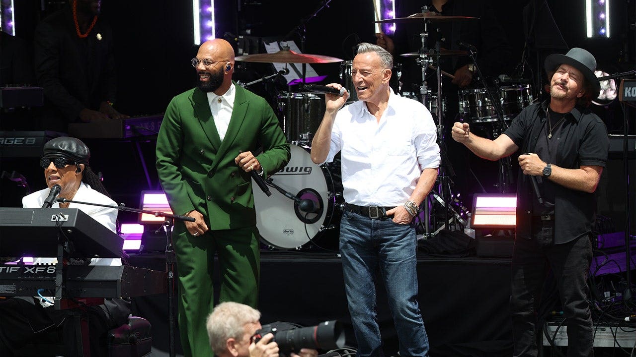 Stevie Wonder, Common, Bruce Springsteen and Eddie Vedder perform together onstage during the Obama Presidential Center dedication ceremony.