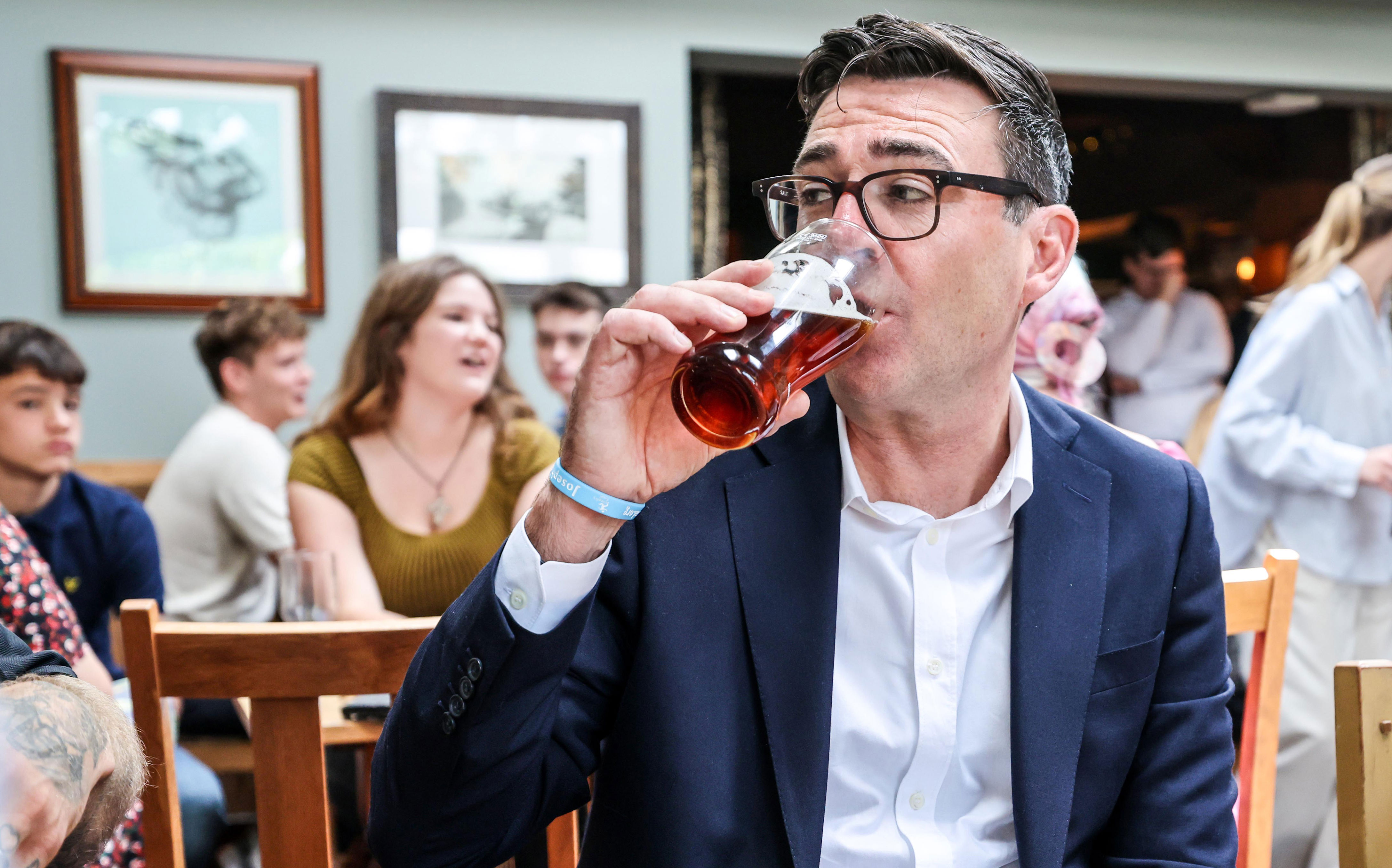 Prime Minister Andy Burnham drinks a beer during a visit to the Hare pub in Harlow, Essex, to highlight the work the Government is doing to support the industry (Richard Pohle/The Times/PA) (PA Wire)