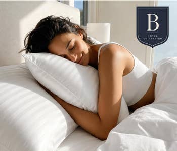 Model smiling, hugging a pillow in a luxurious setting. Text:
