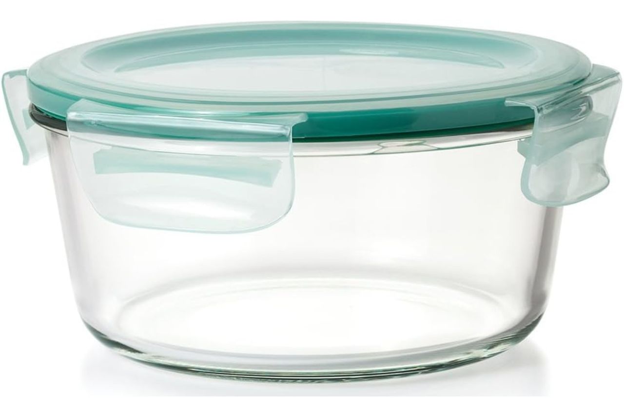 A round glass food container with an airtight lid and locking clips designed for storage