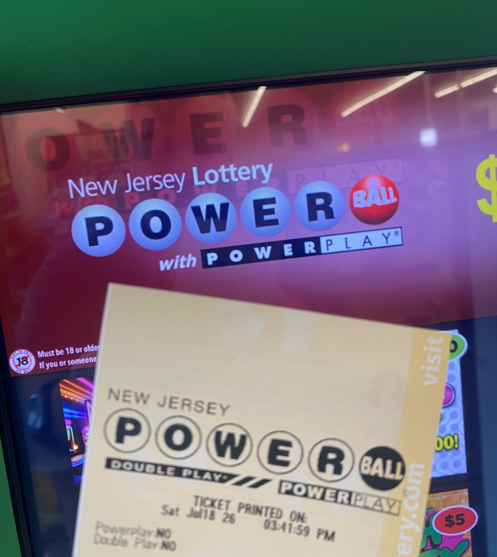 A Powerball ticket and the Powerball logo on a vending machine in Bloomfield, N.J.