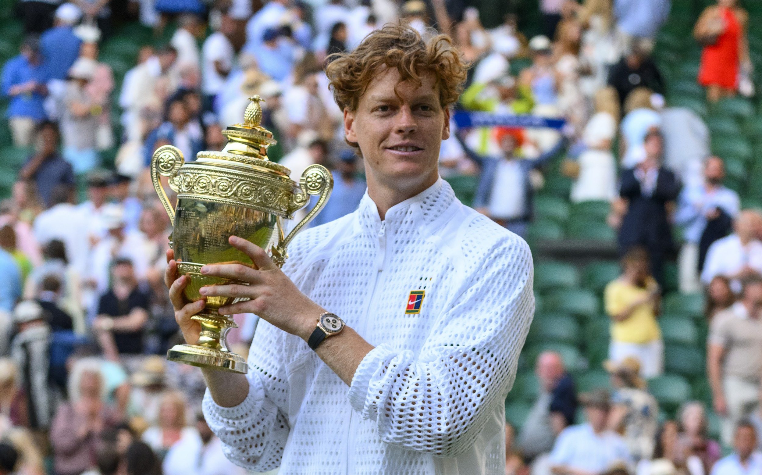 Jannik Sinner holds the Wimbledon mens singles trophy