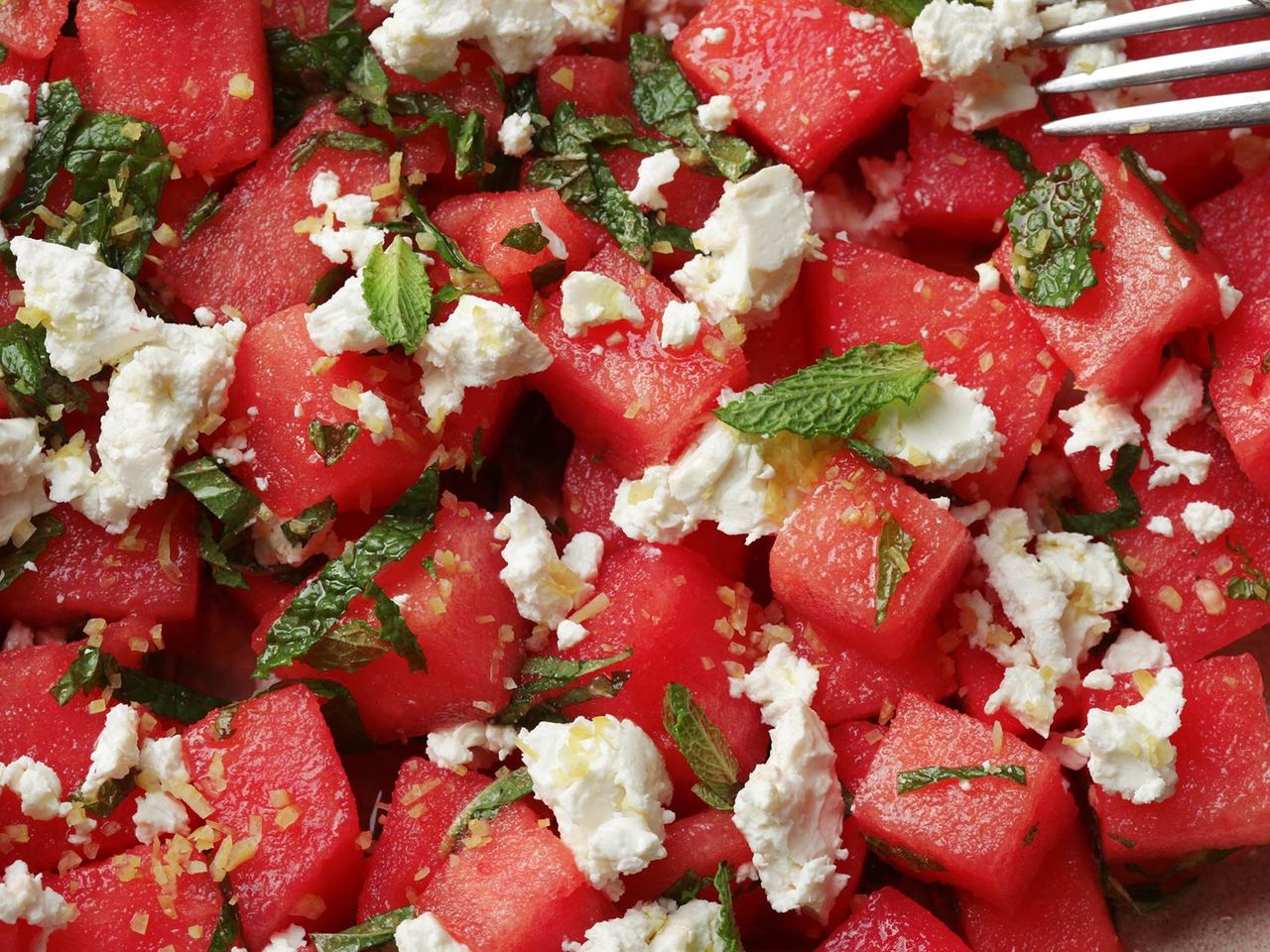 Close-up of cubed watermelon, mint, feta, and lemon zest
