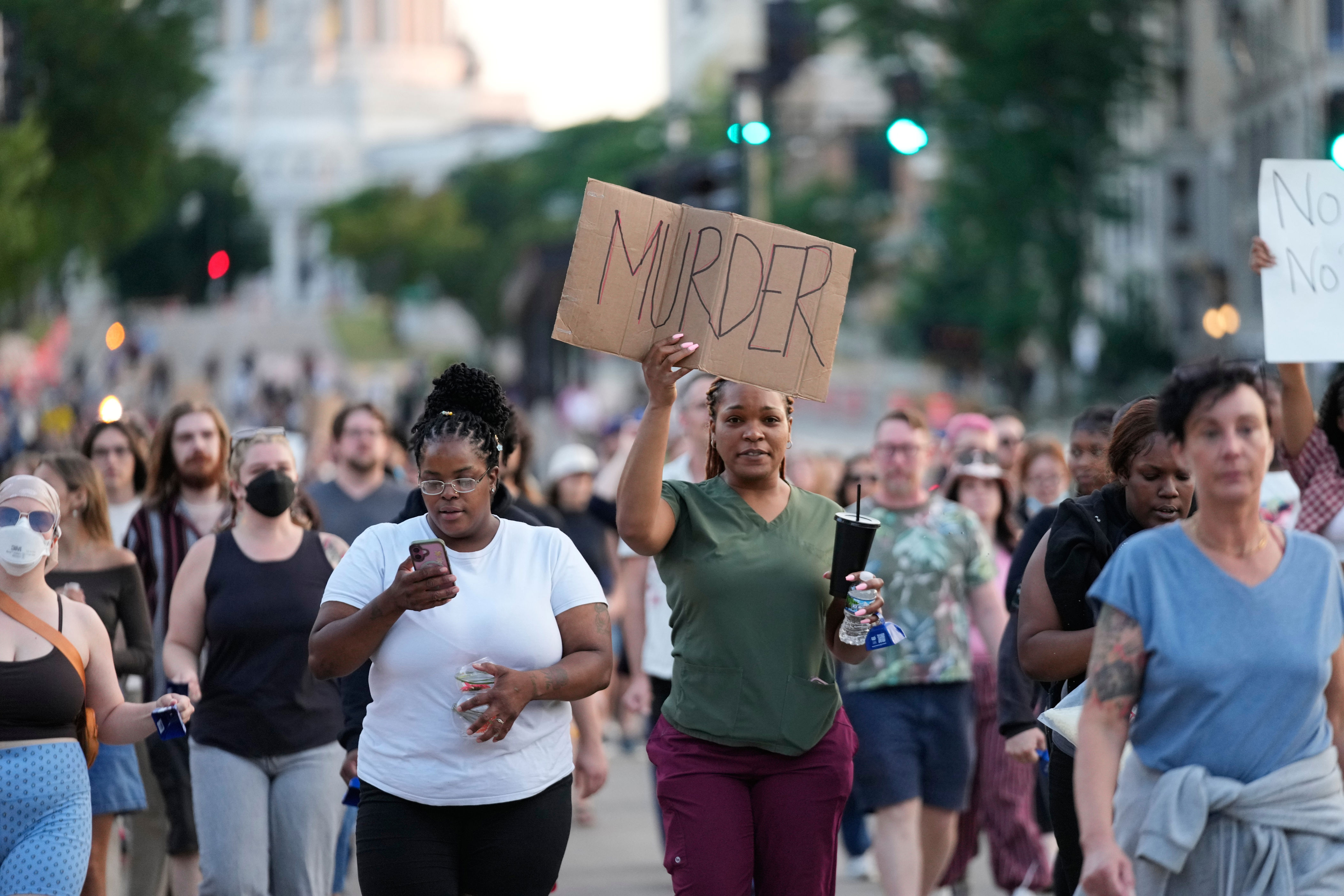 Protesters march after a police officer shot and killed a man Wednesday in Madison, Wisconsin (AP)