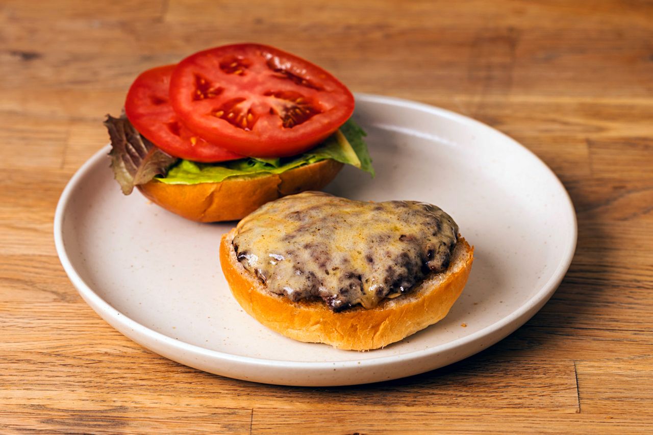 Havarti cheeseburger on a plate with lettuce tomato and cheese