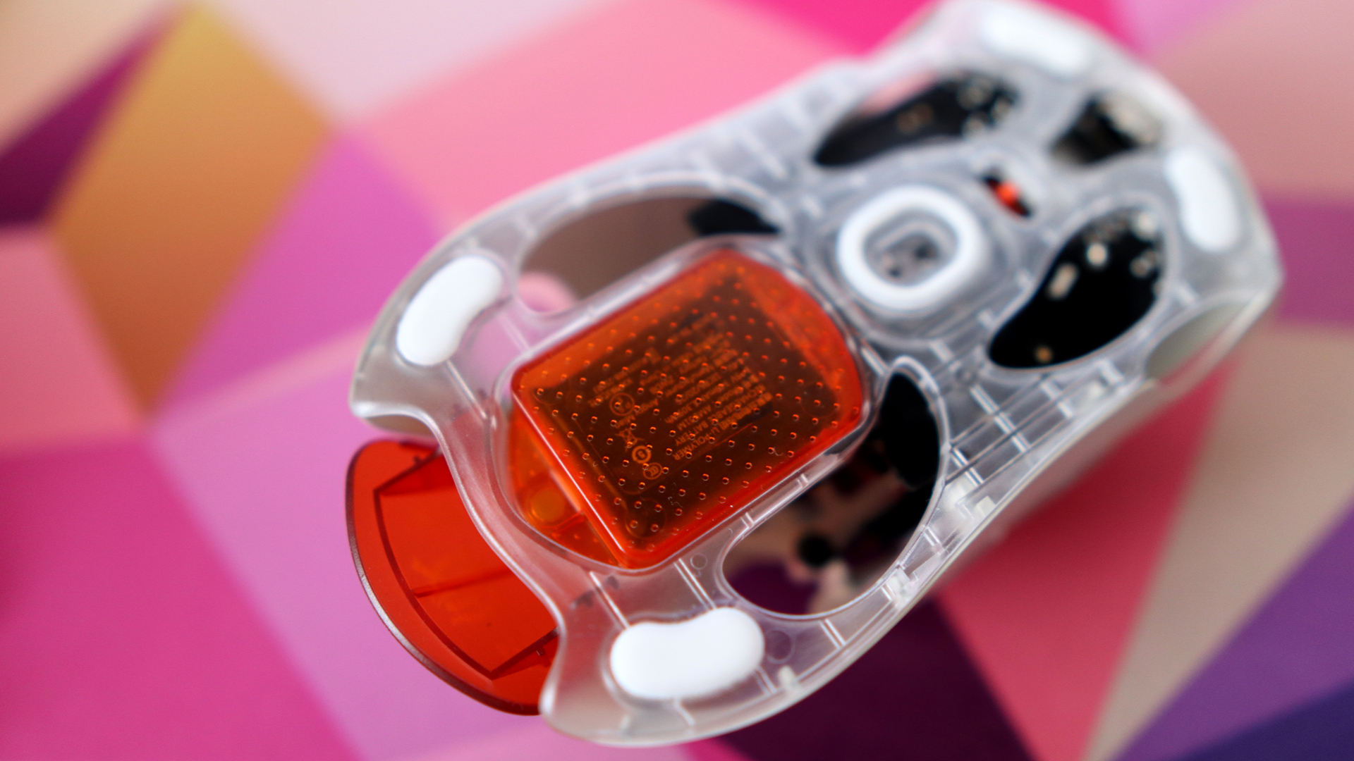 AngryMiao AM Infinity.97 gaming mouse on a colorful desk