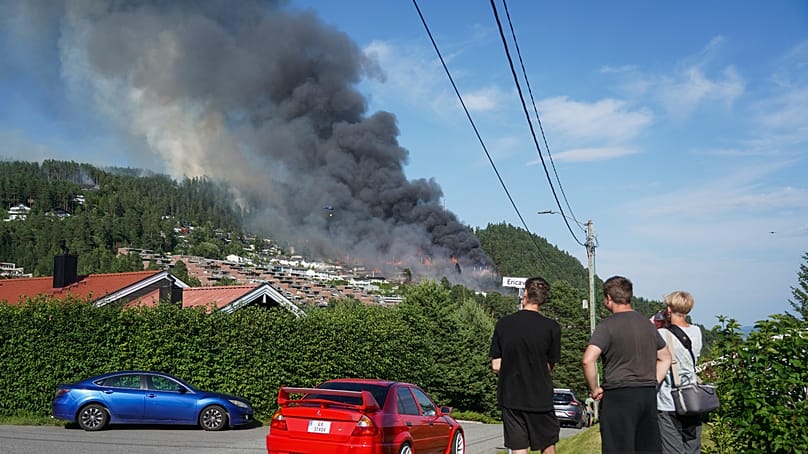 Smoke rises over terraced houses on fire in the Krokstadelva village in Drammen, Norway, Friday. July 17, 2026. (Thomas Fure/NTB Scanpix via AP)