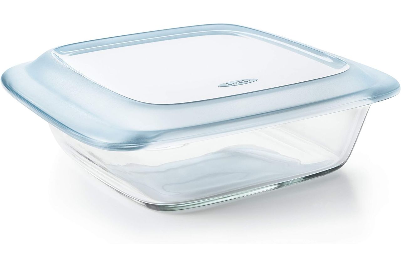 A square glass baking dish with a lid branded by OXO