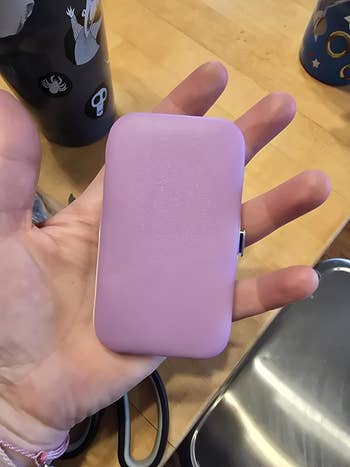 hand holding compact nail case closed