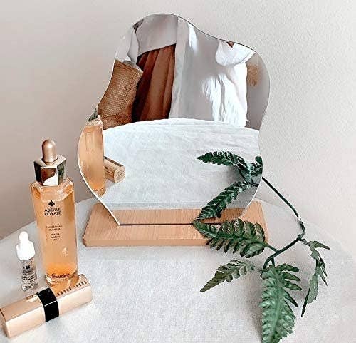 wavy shape mirror in wooden stand