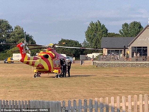 An air ambulance near the scene of the tragedy in West Mersea, Essex yesterday - one person was airlifted to hospital and a further three taken by road