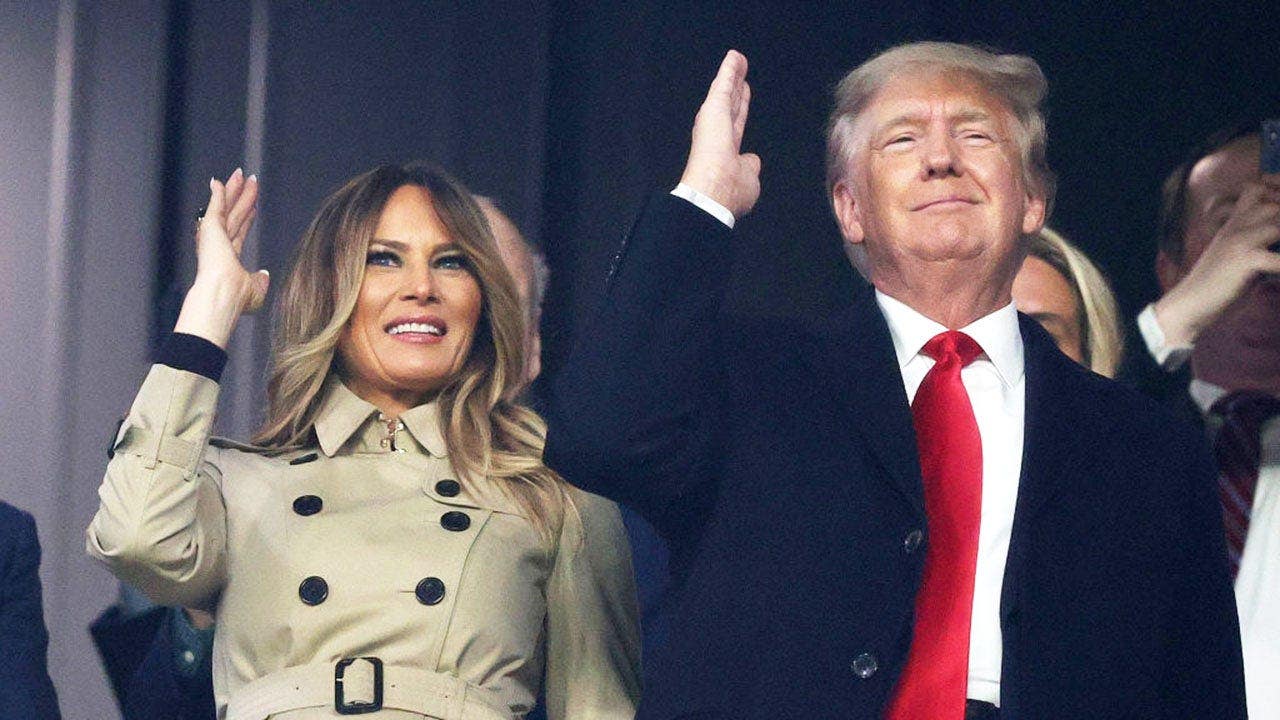 Melania and Donald Trump do the chop before a baseball game in Atlanta.