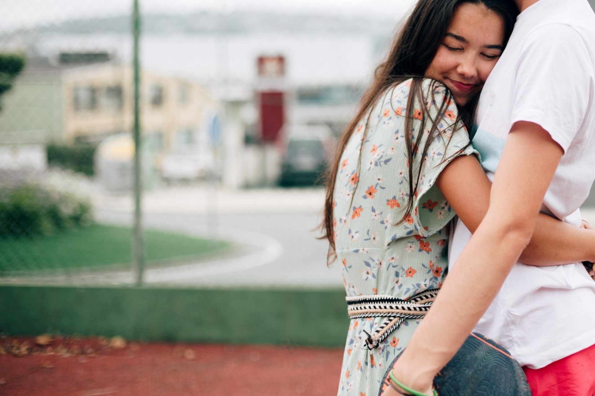 A teenage couple cuddling.