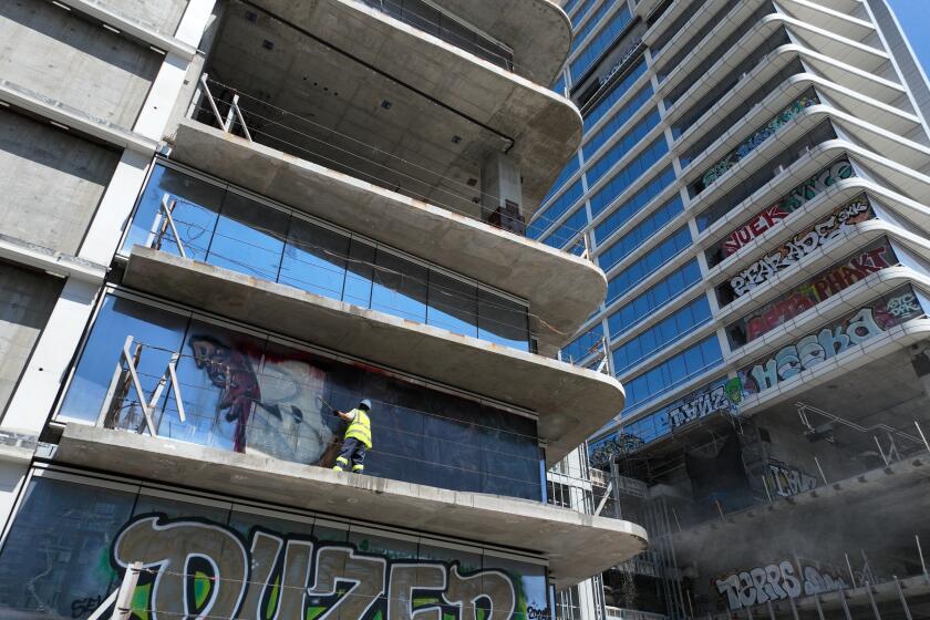 Graffiti towers clean-up begins