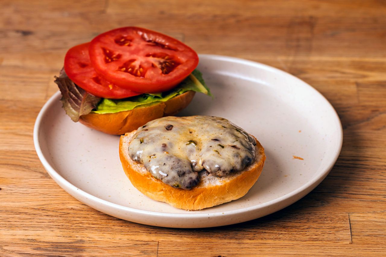 Pepper Jack Cheeseburger on a plate with bun sections topped with lettuce and tomato