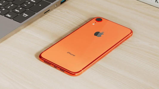 An iPhone XR in Coral; a highly-saturated, vibrant orange