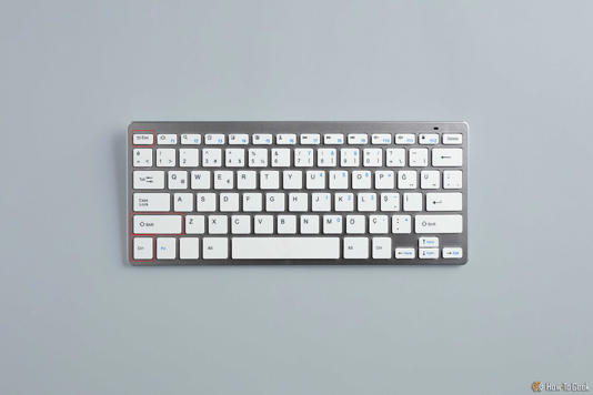 AN image of a keyboard on a desk. The CTRL + Shift + Escape keys are highlighted in red.