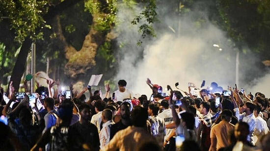 Police personnel use tear gas to disperse protesters during Cockroach Janata Party (CJP ) demonstration at Jantar Mantar on Wednesday, July 22