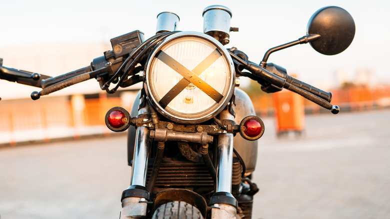 Why do bikers put an X over their motorcycle headlights?