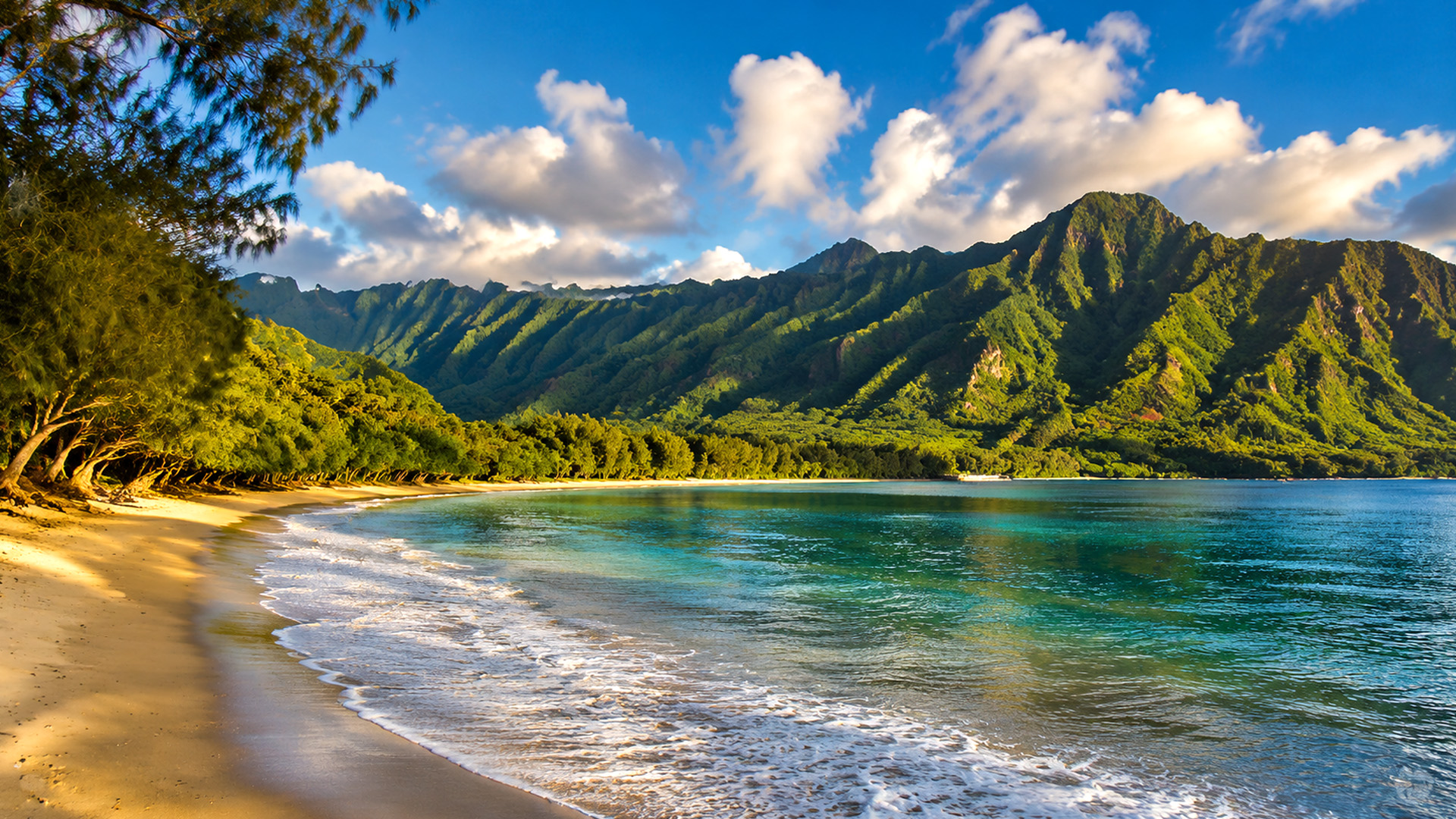 Kahana Bay surrounded by beach and mountain scenery
