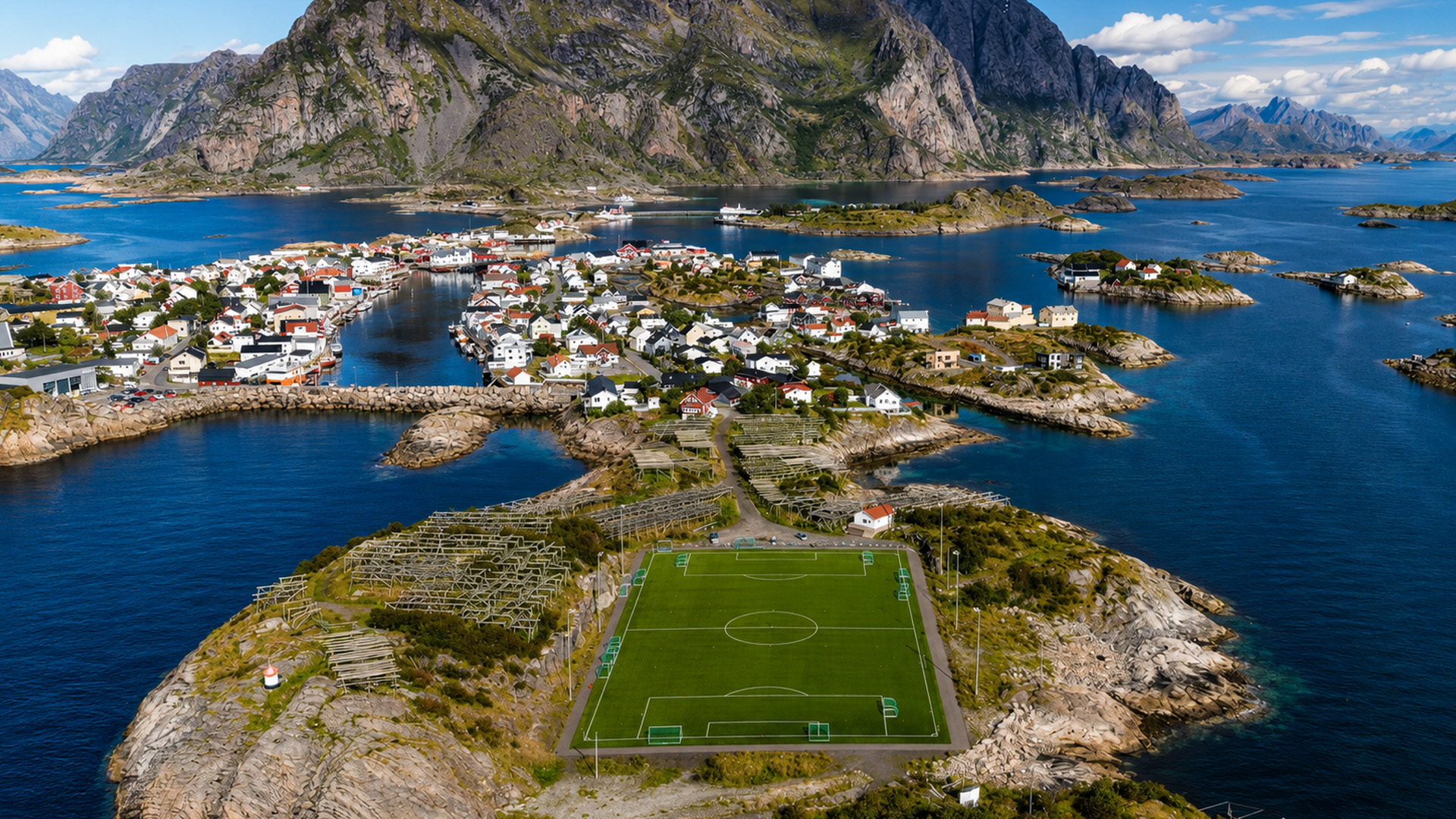 A football field surrounded by the sea