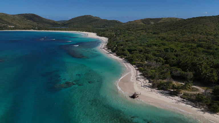 Flamenco Beach in Puerto Rico boasts calm waters, ideal for a relaxing getaway. @Shutterstock/Cima Puerto Rico JP