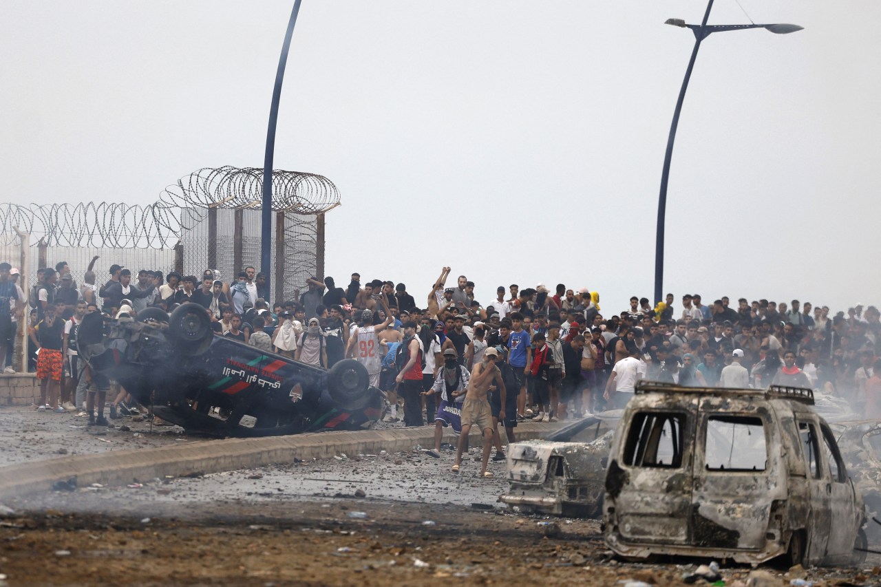 Spain rushes to control border after tens of thousands of migrants flood into exclave