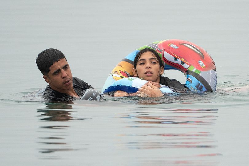 Migrants swim around a border barrier with Morocco to enter Spain's north Africa's Ceuta enclave on July 31, 2026