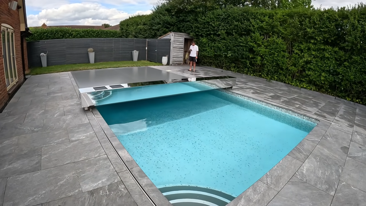 This automatic cover keeps the pool clean - and you can walk on it