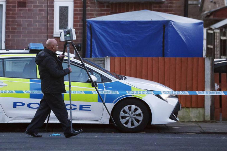 Police at the scene of the stabbing on Tarn Drive in Bury