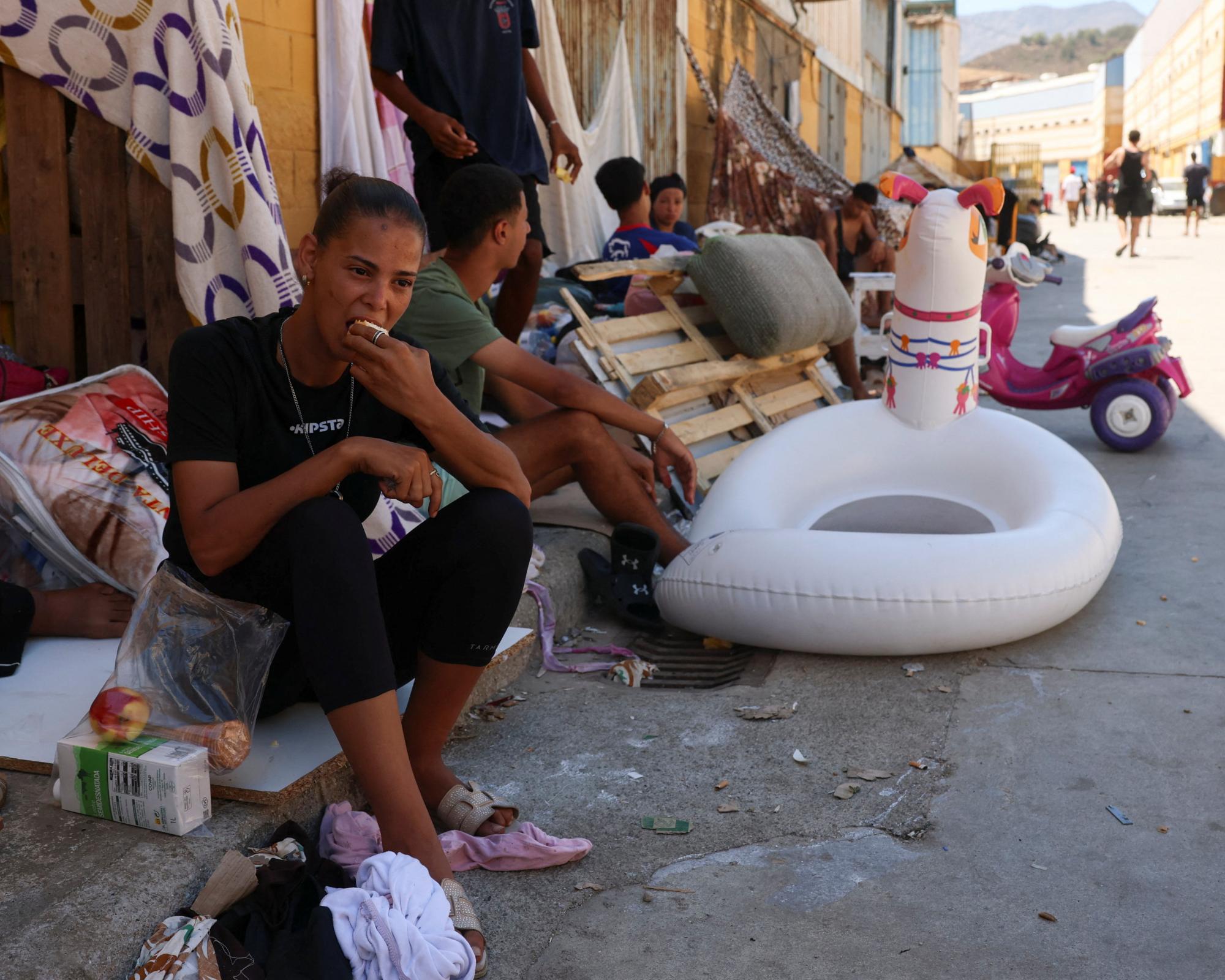 A woman from Morocco and other migrants wait and sleep in the open in Ceuta, Spain, on Thursday. Photograph: Violeta Santos Moura/Reuters