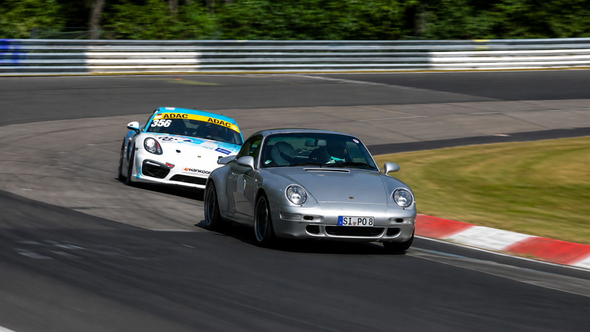 Porsche 911 battles Porsche Cayman GT4 at Nürburgring corner