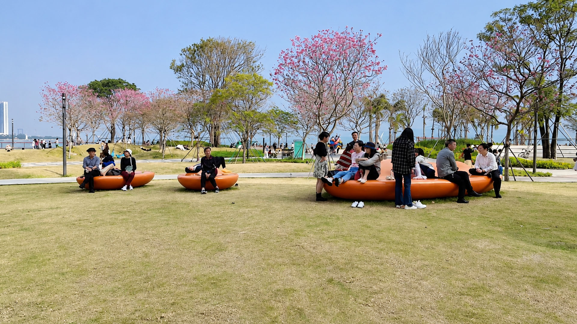 Visitors enjoy open green spaces beside China's mega shopping destination