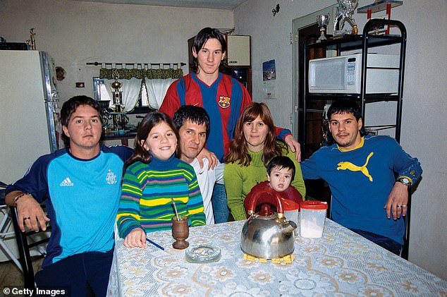 Messi stands in front of his family (including father Jorge (third left) in Rosario in October 2003