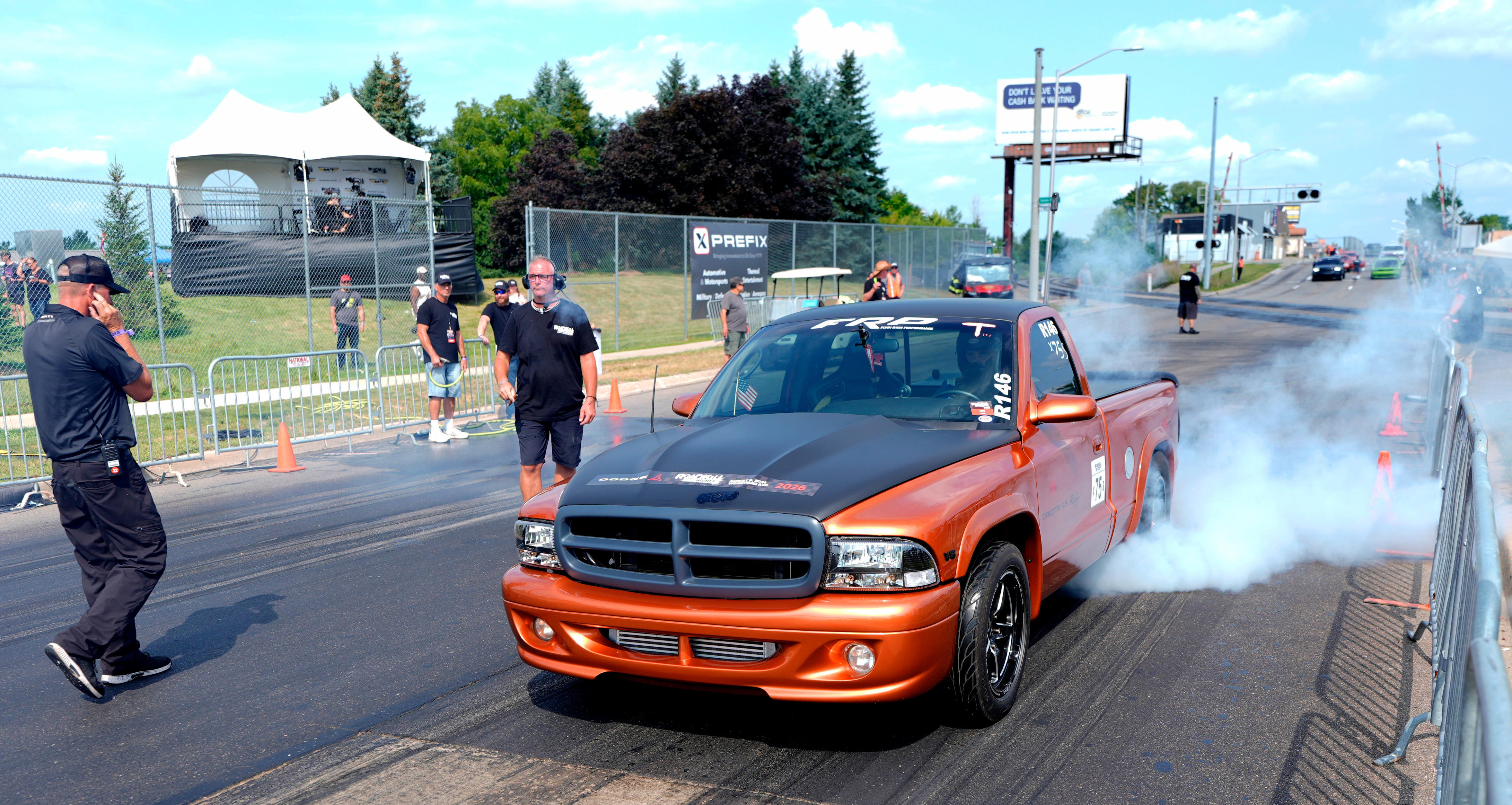 A driver has his Dodge Ram pickup truck do a burnout to warm up the tires before going fast down the eighth of a mile straight on Woodward Avenue during Roadkill Nights at the M1 Concourse in Pontiac on Saturday, August 8, 2026.
