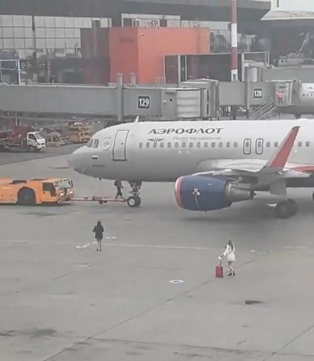 Two late-running passengers made a desperate dash across an airport tarmac in high heels after apparently missing their flight