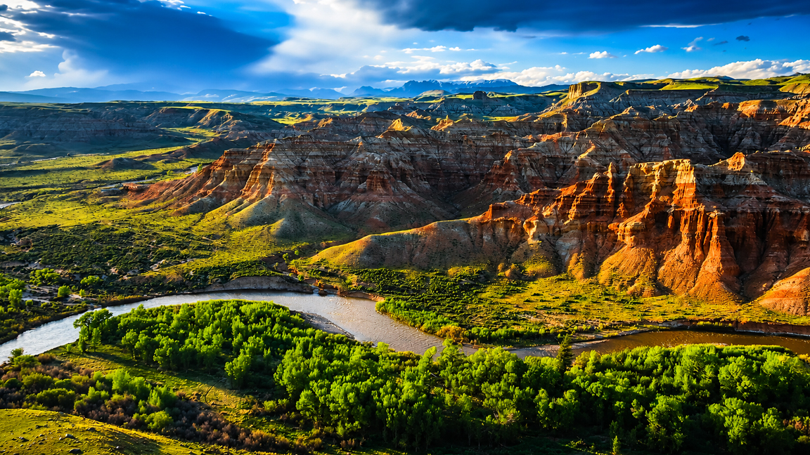 Towering rock formations above a peaceful river valley
