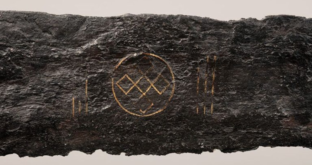 Workers dredging a river in the Netherlands happen upon a medieval sword inscribed with a Viking symbol