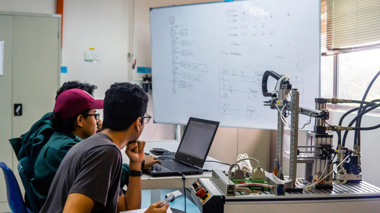Students discuss an automation machine system in a laboratory in Bangi, Malaysia. The Malaysian government is seeking to advance the country's semiconductor sector under its 2030 master plan. Photo: TNS