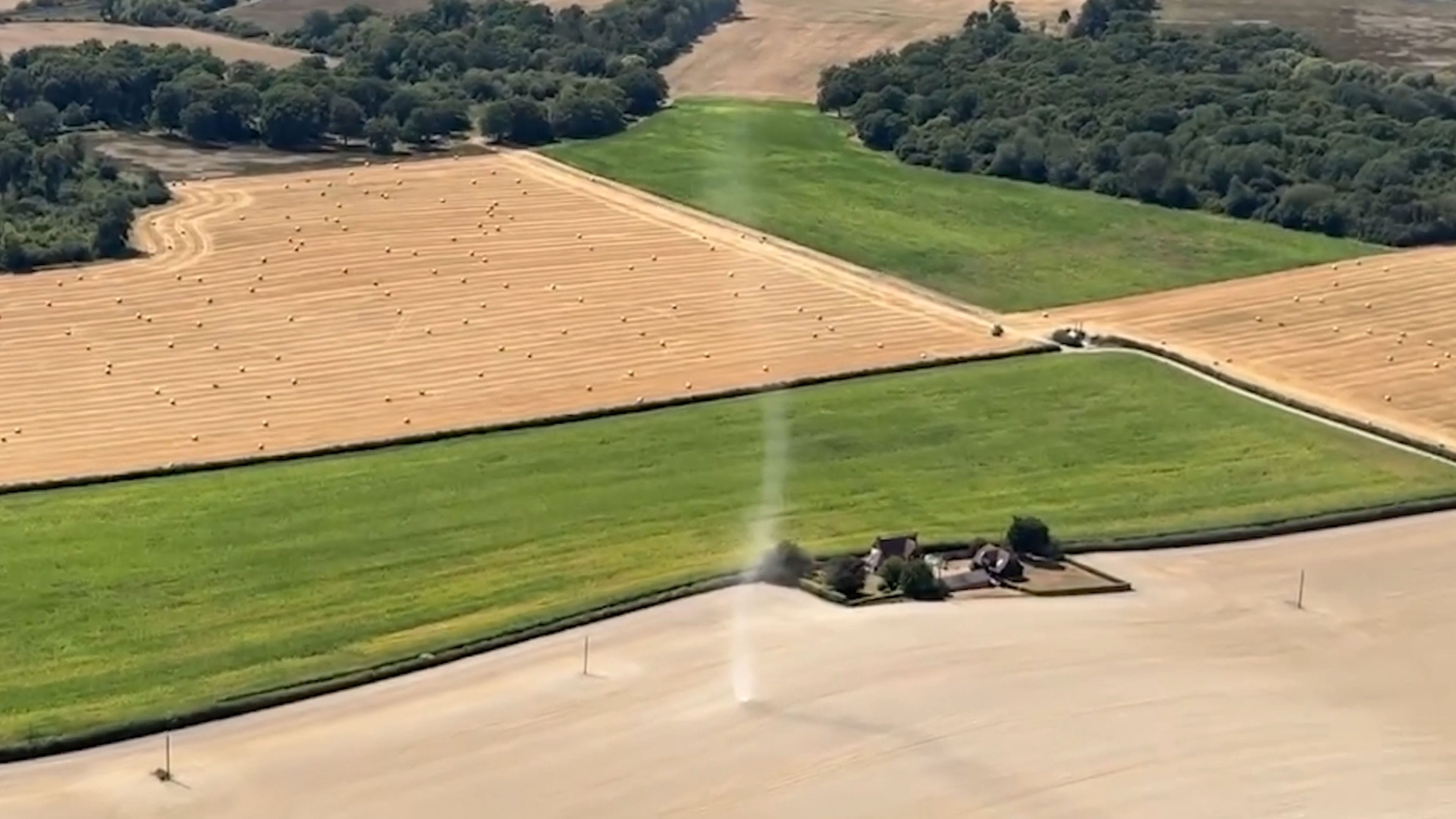 Dust devil spins across dry Kent field