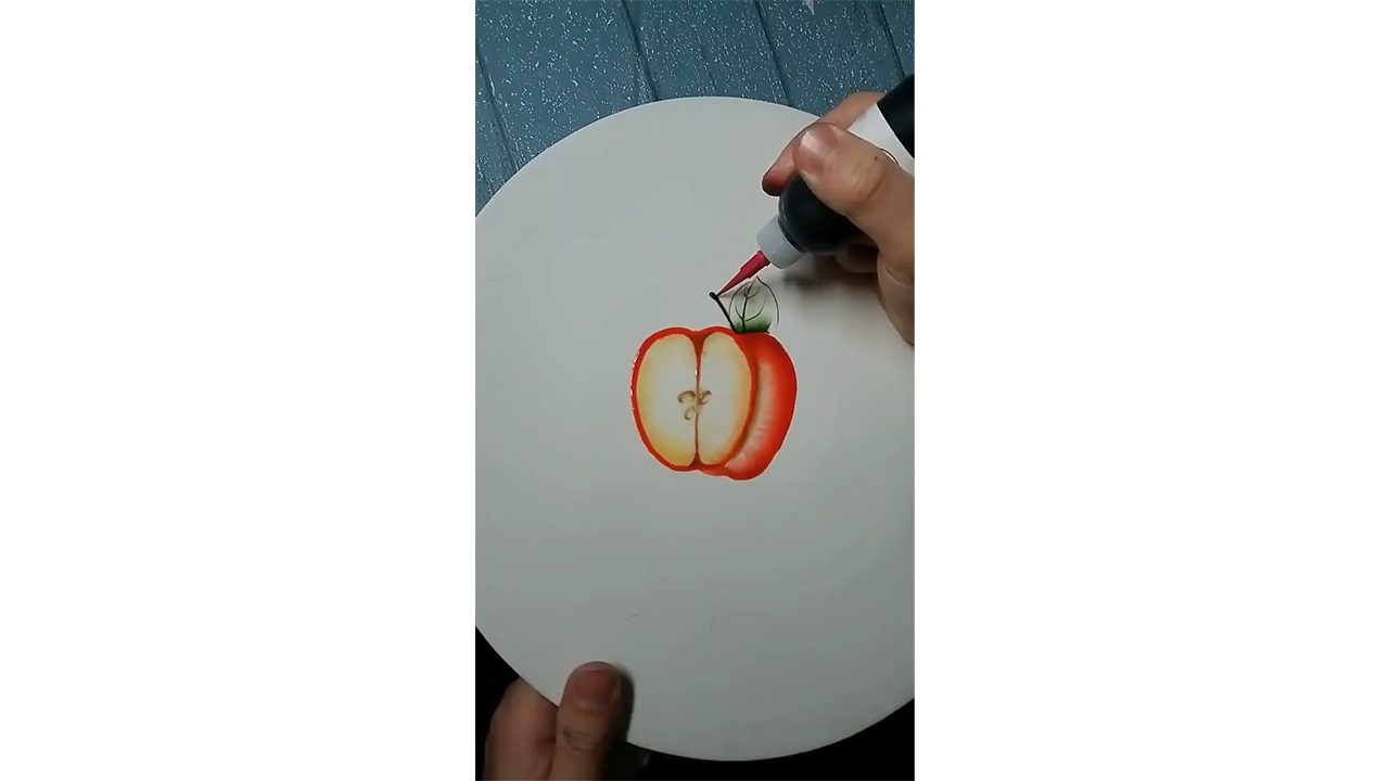 Drawing realistic red apple slice with colored ink creating fresh fruit ...